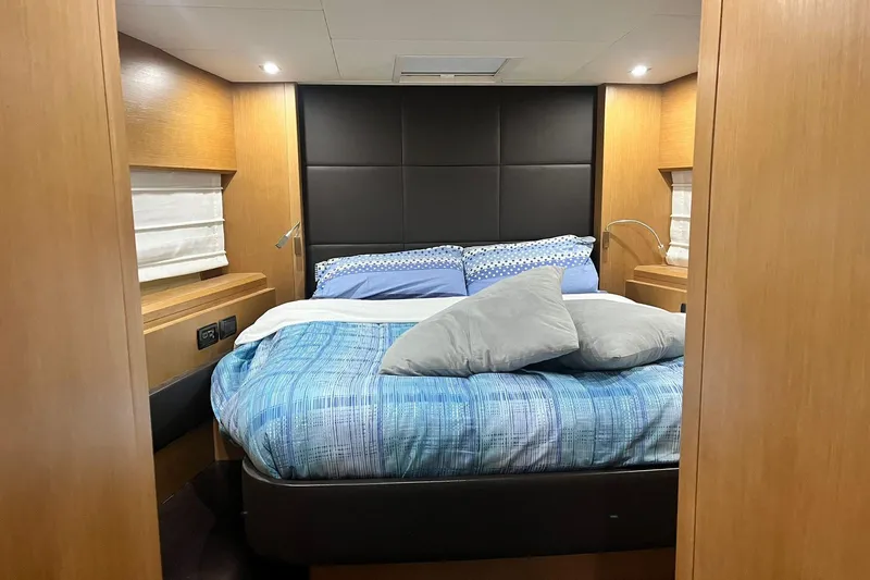  Yacht Photos Pics Luxurious bedroom interior of 2011 Cayman Yachts 60 HT with modern design and cozy bedding.