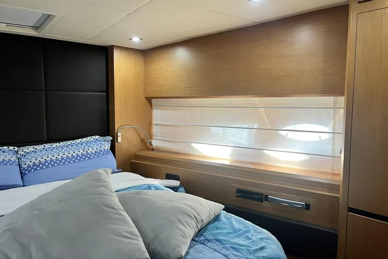  Yacht Photos Pics Luxurious bedroom interior of 2011 Cayman Yachts 60 HT with modern design and cozy bedding.