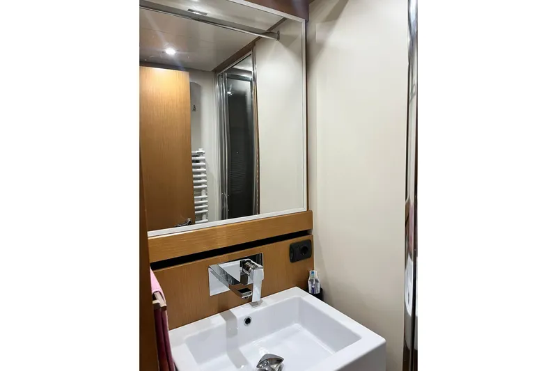  Yacht Photos Pics Modern bathroom interior on 2011 Cayman Yachts 60 HT, featuring sleek sink and mirror.