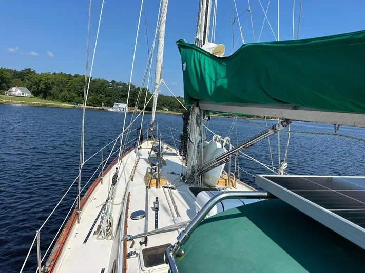 Lagniappe Yacht Photos Pics Sailboat on water, Pacific Seacraft Crealock 44, 1990 model, with green sail cover.