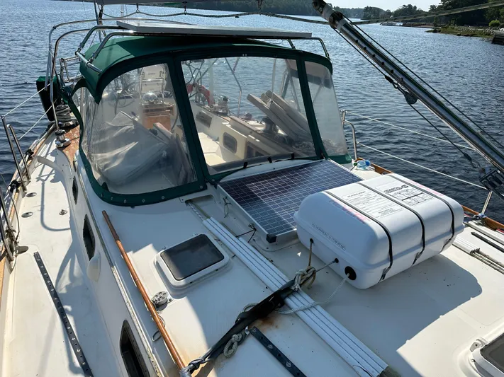 Lagniappe Yacht Photos Pics 1990 Pacific Seacraft Crealock 44 sailboat with solar panel and life raft on deck.