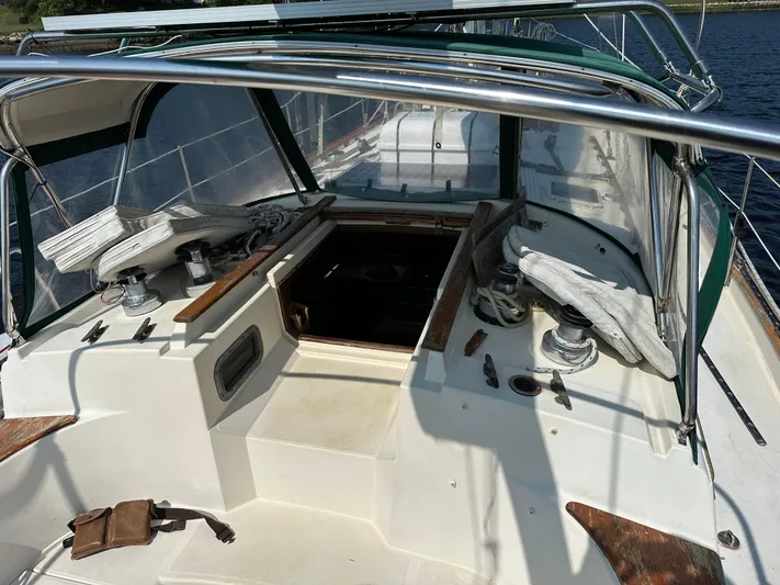 Lagniappe Yacht Photos Pics Cockpit of 1990 Pacific Seacraft Crealock 44 sailboat with winches and covered seating.