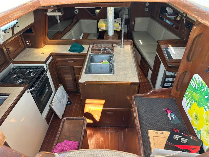 Lagniappe Yacht Photos Pics Interior of 1990 Pacific Seacraft Crealock 44 sailboat with kitchen and seating area.
