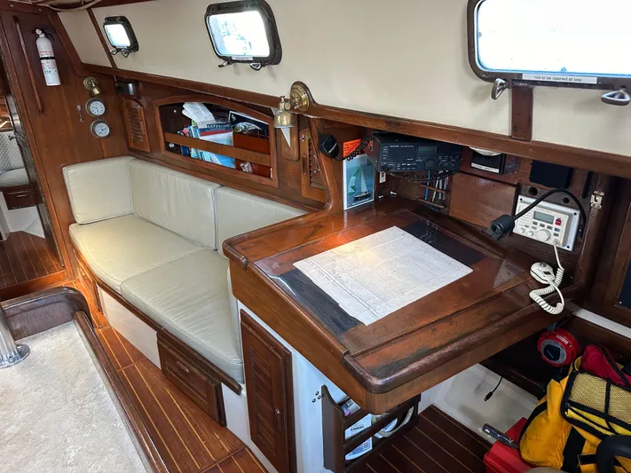 Lagniappe Yacht Photos Pics 1990 Pacific Seacraft Crealock 44 interior with navigation station and seating area.