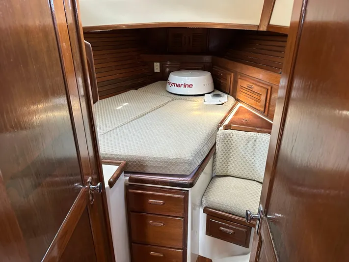 Lagniappe Yacht Photos Pics Cozy cabin interior of 1990 Pacific Seacraft Crealock 44 sailboat with wooden cabinetry.