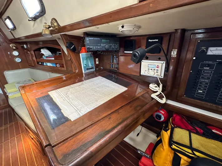 Lagniappe Yacht Photos Pics Navigation station inside 1990 Pacific Seacraft Crealock 44 sailboat, featuring chart table and equipment.