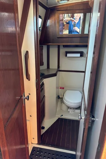 Lagniappe Yacht Photos Pics 1990 Pacific Seacraft Crealock 44 yacht bathroom with wooden accents and compact design.