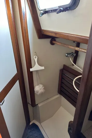 Lagniappe Yacht Photos Pics Bathroom interior of a 1990 Pacific Seacraft Crealock 44 sailboat, featuring wooden accents.