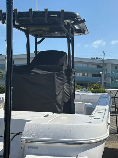  Yacht Photos Pics 2023 Caymas 28 HB boat with T-top and covered console, docked under clear blue sky.