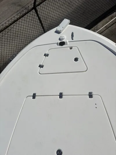  Yacht Photos Pics 2023 Caymas 28 HB boat deck with storage compartments and hardware.