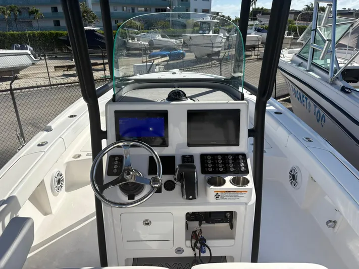  Yacht Photos Pics 2023 Caymas 28 HB boat dashboard with steering wheel and navigation screens.