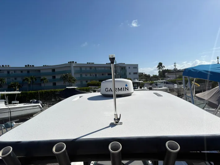  Yacht Photos Pics 2023 Caymas 28 HB boat with Garmin equipment, docked under clear blue sky.