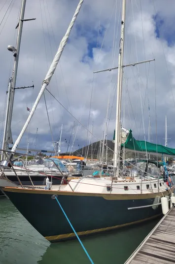 Lagniappe Yacht Photos Pics Sailboat docked at marina, Pacific Seacraft Crealock 44, 1990 model, under cloudy sky.
