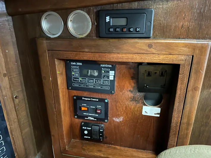 Lagniappe Yacht Photos Pics Control panel of a 1990 Pacific Seacraft Crealock 44 sailboat with various switches and gauges.