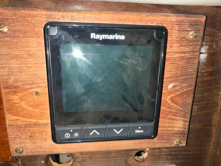 Lagniappe Yacht Photos Pics Raymarine display on 1990 Pacific Seacraft Crealock 44 sailboat, mounted on wooden panel.