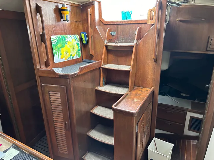 Lagniappe Yacht Photos Pics Interior of 1990 Pacific Seacraft Crealock 44 sailboat with wooden stairs and storage.