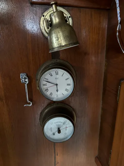 Lagniappe Yacht Photos Pics Brass clock and barometer on 1990 Pacific Seacraft Crealock 44 yacht interior.