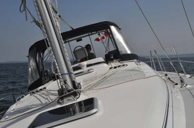 Inspiration VI Yacht Photos Pics Sailing on a 2006 Hunter 41 yacht with Canadian flag in open waters.