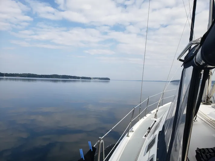 Inspiration VI Yacht Photos Pics Sailing on calm waters with a 2006 Hunter 41 under a partly cloudy sky.