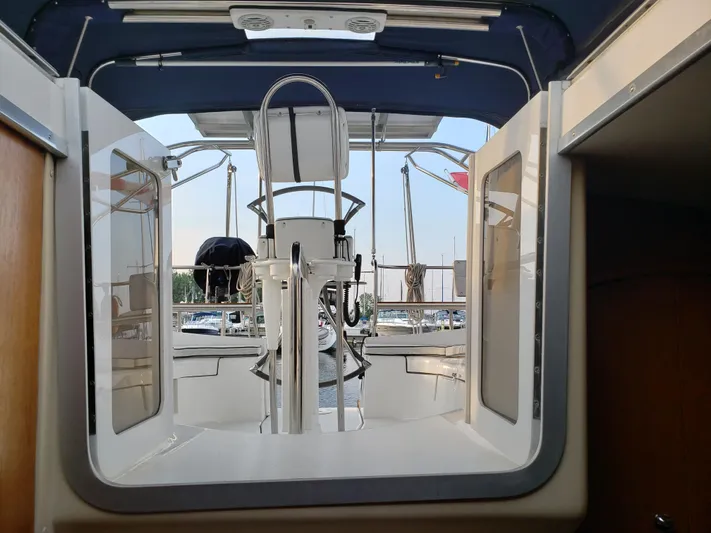 Inspiration VI Yacht Photos Pics Cockpit view of 2006 Hunter 41 sailboat with marina background.