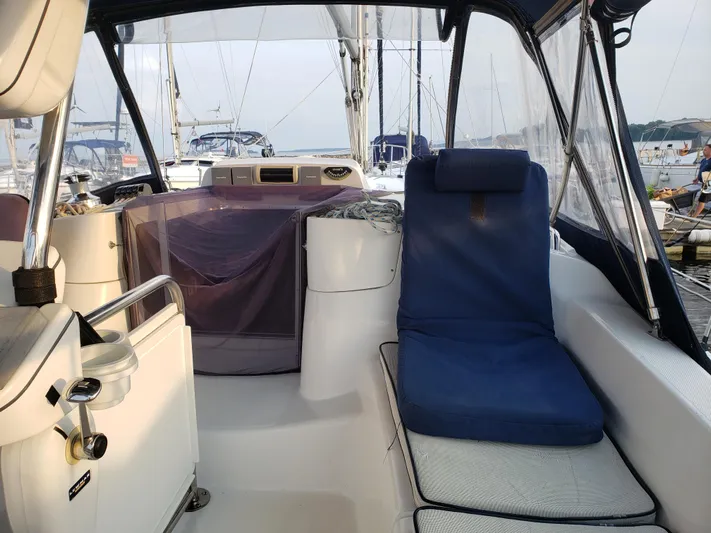 Inspiration VI Yacht Photos Pics 2006 Hunter 41 sailboat cockpit with blue seating, marina background.