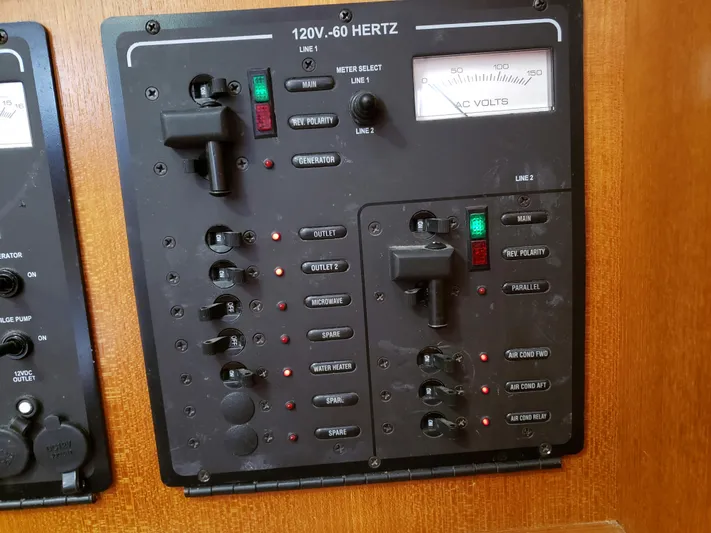 Inspiration VI Yacht Photos Pics Electrical control panel on a 2006 Hunter 41 boat, featuring switches and voltage meter.