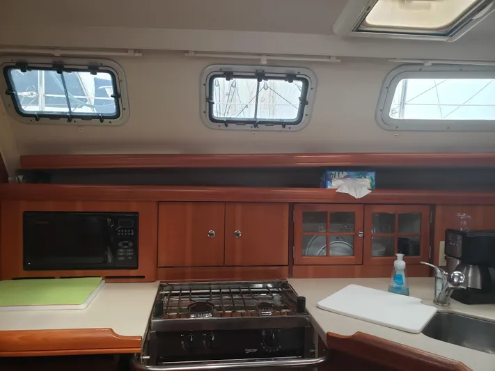 Inspiration VI Yacht Photos Pics Interior of 2006 Hunter 41 sailboat kitchen with stove, microwave, and cabinets.