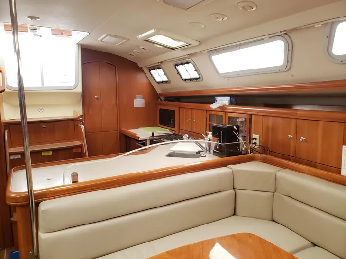 Inspiration VI Yacht Photos Pics Interior of 2006 Hunter 41 sailboat with cozy seating and wooden cabinetry.
