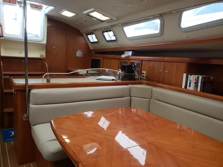 Inspiration VI Yacht Photos Pics Luxurious interior of 2006 Hunter 41 sailboat with wood finish and comfortable seating.