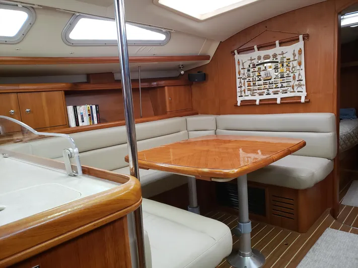 Inspiration VI Yacht Photos Pics Interior of 2006 Hunter 41 sailboat with wooden dining area and beige seating.