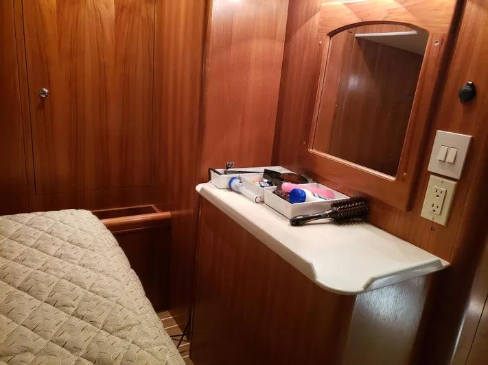 Inspiration VI Yacht Photos Pics Interior of 2006 Hunter 41 yacht with wooden cabinetry and a small vanity area.