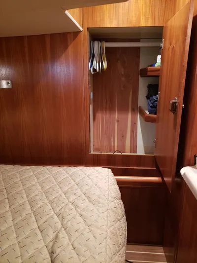 Inspiration VI Yacht Photos Pics Interior cabin of 2006 Hunter 41 sailboat with wood paneling and cozy bedding.