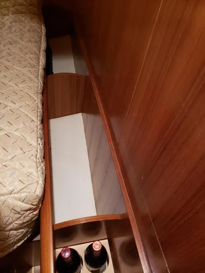 Inspiration VI Yacht Photos Pics Interior of 2006 Hunter 41 sailboat with wooden storage and wine bottles.
