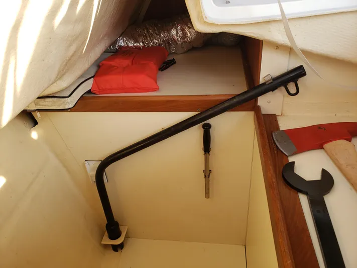 Inspiration VI Yacht Photos Pics Storage compartment in a 2006 Hunter 41 sailboat with tools and safety equipment.