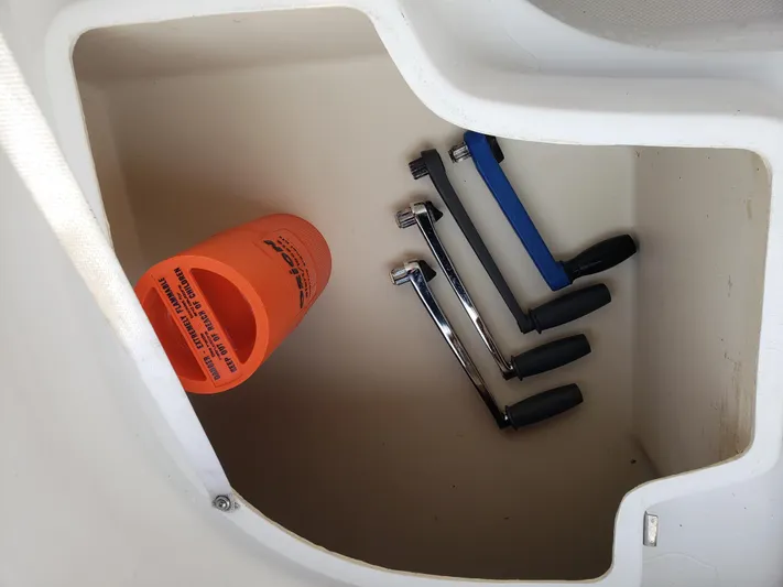 Inspiration VI Yacht Photos Pics Storage compartment with tools and an orange safety float on a 2006 Hunter 41 boat.