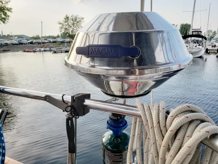 Inspiration VI Yacht Photos Pics Stainless steel Magma grill on a 2006 Hunter 41 sailboat, docked by the water.