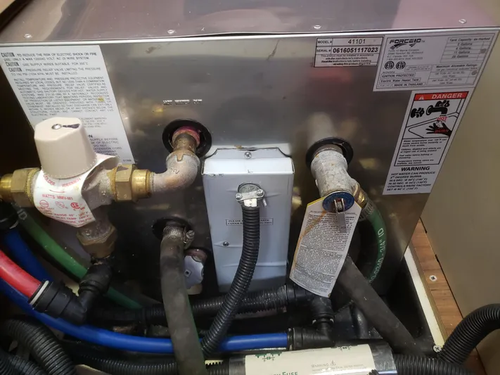 Inspiration VI Yacht Photos Pics Plumbing system of a 2006 Hunter 41 boat with various pipes and labels.