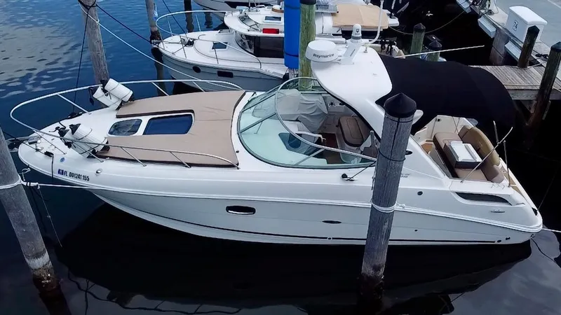  Yacht Photos Pics 2012 Sea Ray 310 Sundancer boat docked at marina, featuring sleek design and spacious deck.