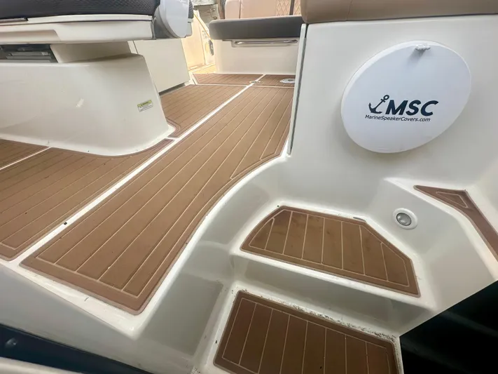  Yacht Photos Pics 2012 Sea Ray 310 Sundancer boat deck with brown flooring and MSC logo.