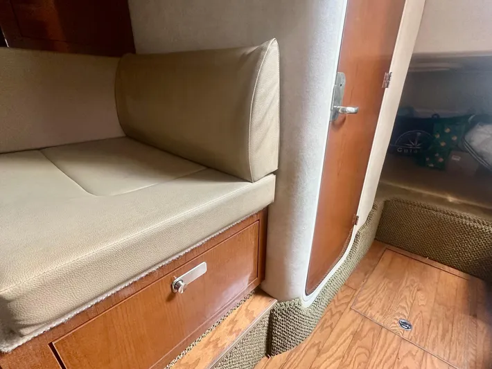  Yacht Photos Pics Interior of 2012 Sea Ray 310 Sundancer with beige seating and wooden cabinetry.