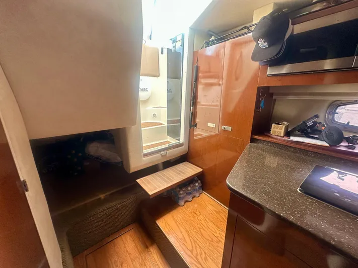  Yacht Photos Pics Interior of 2012 Sea Ray 310 Sundancer yacht, featuring wood finishes and compact design.