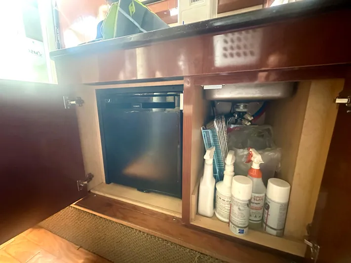  Yacht Photos Pics 2012 Sea Ray 310 Sundancer cabinet with cleaning supplies and mini fridge.