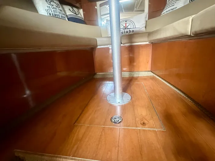  Yacht Photos Pics Interior of 2012 Sea Ray 310 Sundancer with polished wood flooring and cushioned seating.