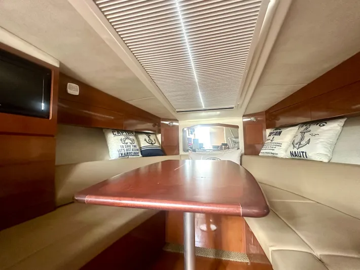  Yacht Photos Pics Interior of 2012 Sea Ray 310 Sundancer with cozy seating and wooden table.