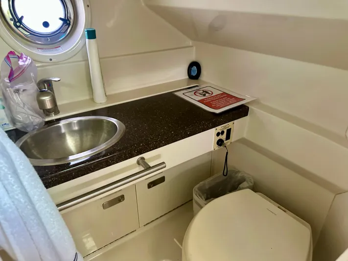  Yacht Photos Pics Bathroom interior of 2012 Sea Ray 310 Sundancer yacht, featuring sink and toilet.