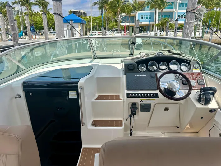  Yacht Photos Pics 2012 Sea Ray 310 Sundancer cockpit with steering wheel, gauges, and seating at marina.