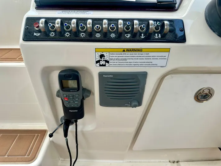  Yacht Photos Pics Control panel of a 2012 Sea Ray 310 Sundancer boat with radio and warning label.