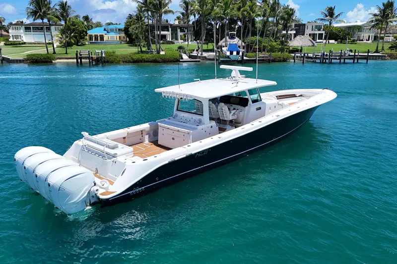  Yacht Photos Pics 2020 HCB 53 Sueños luxury boat on clear blue water, surrounded by palm trees.
