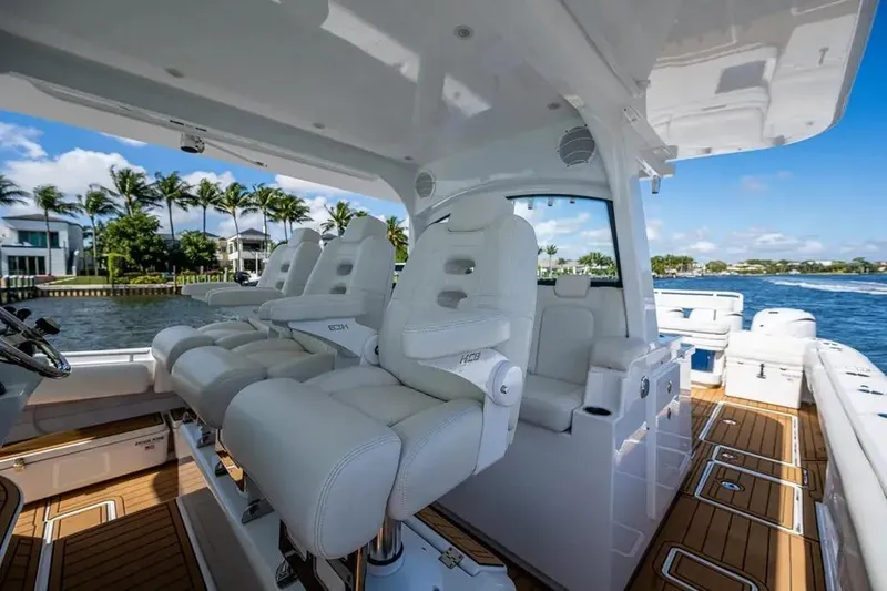  Yacht Photos Pics Luxury interior of 2020 HCB 53 Sueños yacht with plush seating and scenic waterfront view.