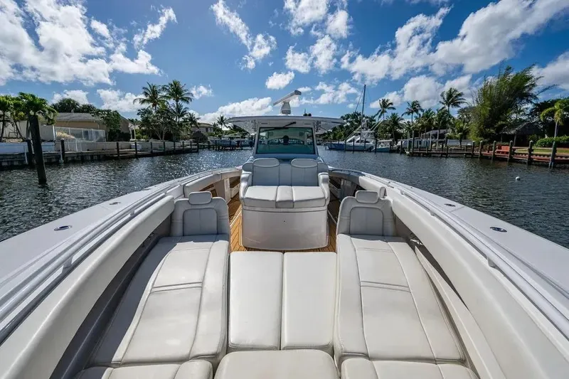  Yacht Photos Pics 2020 HCB 53 Sueños luxury boat with spacious seating, cruising on a sunny waterway.